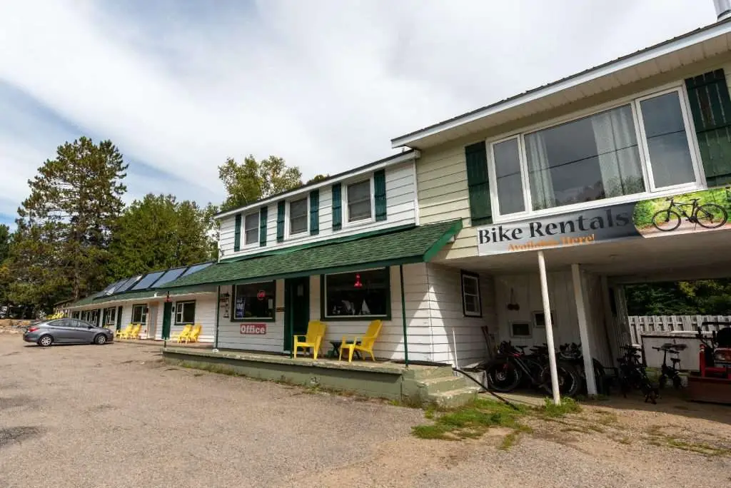 An exterior of East Gate Motel and Office showing the entrance to the rooms and rentals available sign by the office