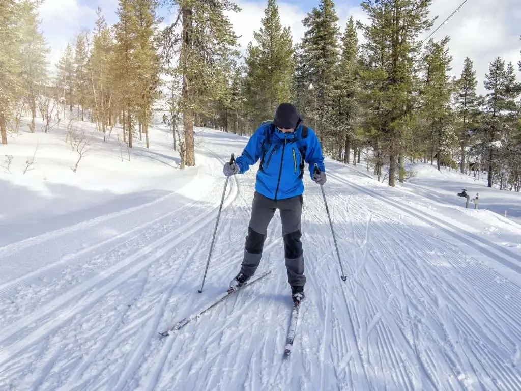 Front view of a man cross-country skiing on the trail in Finland