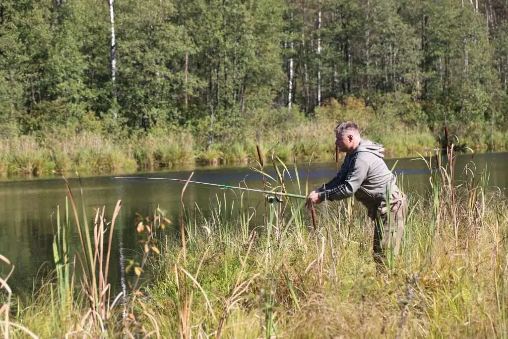 man fishing with a fishing rod in the river