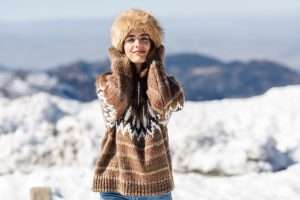 Young woman enjoying the snowy mountains in winter