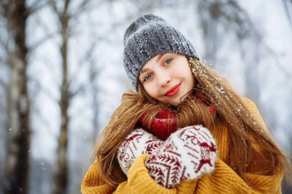 Winter young woman portrait. Beauty Joyful Model Girl laughing and having fun in winter park