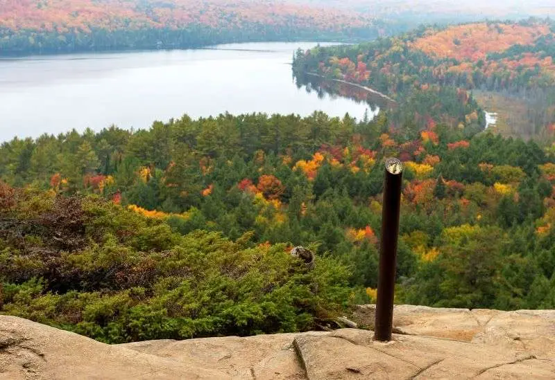 A spectacular lookout from Booths Rock Trail, looking over trees colour changing in Fall in Algonquin Park