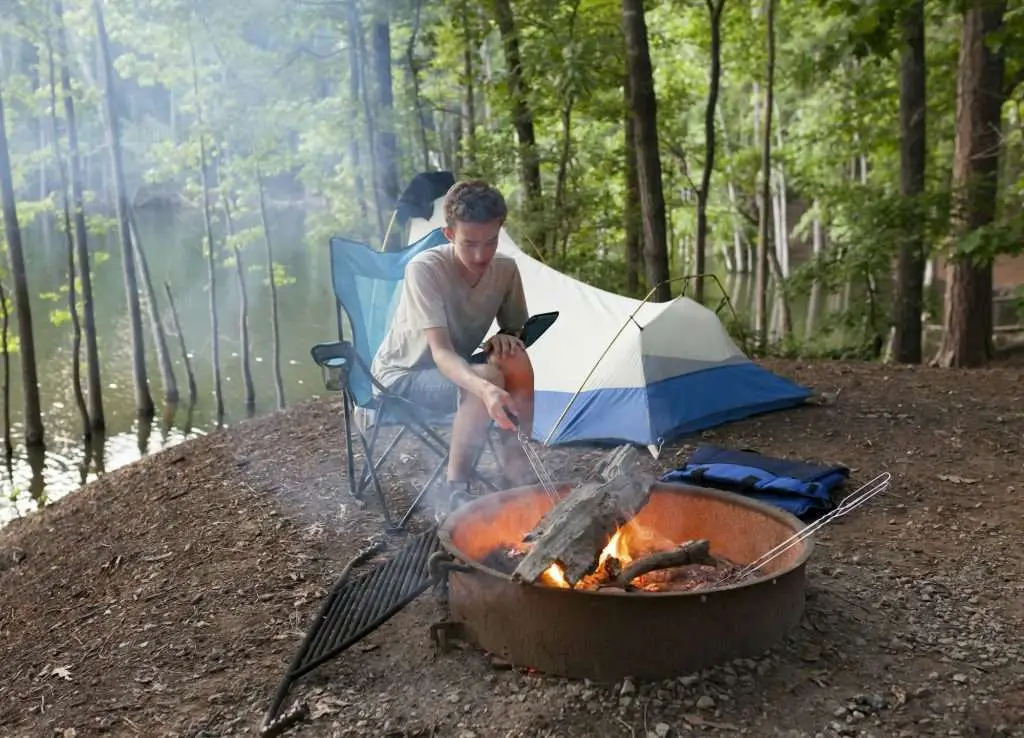 teenager camping with camp fire