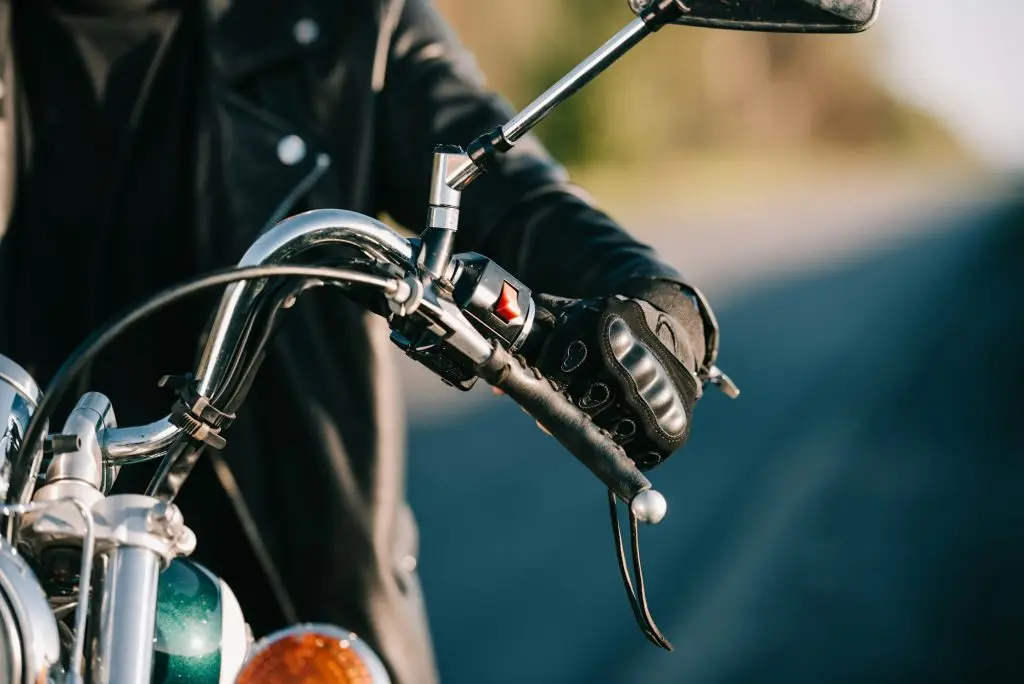 cropped view of biker sitting on classic motorcycle