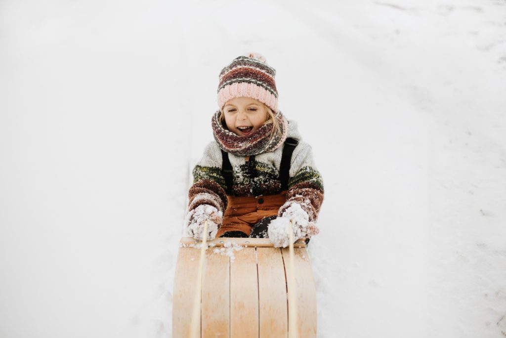 Canada, Ontario, Smiling girl on toboggan