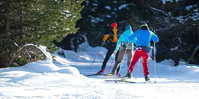 3 girls are skating in snow