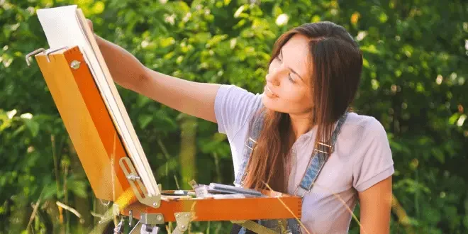 a pretty woman painting outdoor