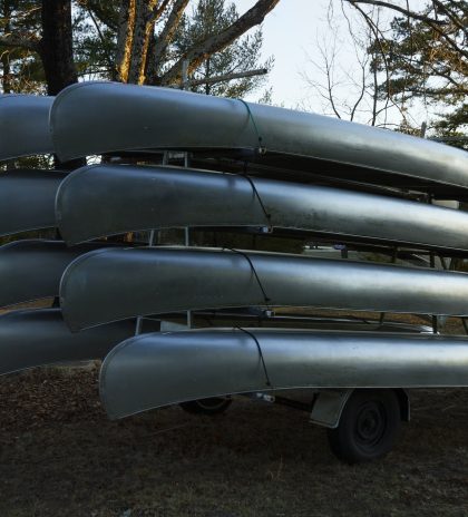 Canoes Stacked Upside Down On Field